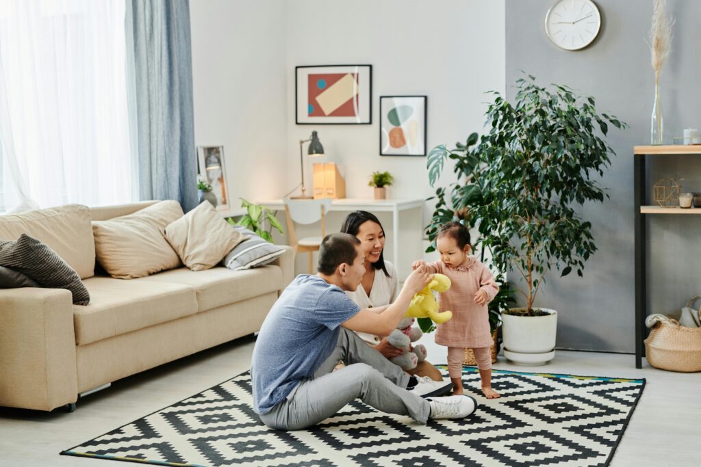pexels-photo-7705898-7705898 A joyful family spending quality time together with their baby indoors.